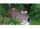 A birdseye view of the property, including a storage building, outdoor deck with furniture, and a car parked in the driveway at 85 Pine Haven Dr, Carrollton, GA 30116