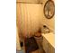 Bathroom featuring a patterned shower curtain, wooden toilet seat, and tree-themed decor at 85 Pine Haven Dr, Carrollton, GA 30116
