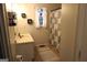 Bathroom with a vanity, window, and shower-tub combination with a patterned shower curtain at 85 Pine Haven Dr, Carrollton, GA 30116
