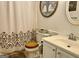 Cozy bathroom with wooden toilet seat, white cabinet, and decorative tree wall art at 85 Pine Haven Dr, Carrollton, GA 30116