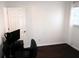 Minimalist bedroom with dark wood floors, white walls, computer desk, and a window bringing in natural light at 85 Pine Haven Dr, Carrollton, GA 30116