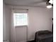 Well-lit bedroom with a large window and comfortable sitting area at 85 Pine Haven Dr, Carrollton, GA 30116