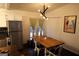 Well lit dining area with french doors, and unique light fixture, stainless steel refrigerator at 85 Pine Haven Dr, Carrollton, GA 30116