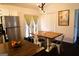 Dining area featuring a rustic wood table, natural light from doors, and view of backyard at 85 Pine Haven Dr, Carrollton, GA 30116