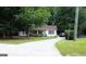 Inviting home featuring a well-manicured lawn, charming front porch, and a long, paved driveway at 85 Pine Haven Dr, Carrollton, GA 30116