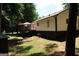 Charming home exterior showcasing a spacious deck, light siding, and beautiful, wooded backyard at 85 Pine Haven Dr, Carrollton, GA 30116