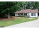 Charming home with beautiful landscaping, a covered front porch, and classic architectural details at 85 Pine Haven Dr, Carrollton, GA 30116