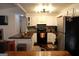 A well-equipped kitchen featuring wood countertops, white cabinets, stainless steel appliances and dark-stained hardwood floors at 85 Pine Haven Dr, Carrollton, GA 30116