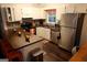 A well-equipped kitchen featuring wood countertops, white cabinets, stainless steel appliances and dark-stained hardwood floors at 85 Pine Haven Dr, Carrollton, GA 30116