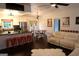 Open-concept living space with modern lighting, dining area, stainless steel appliances, and kitchen island with seating at 85 Pine Haven Dr, Carrollton, GA 30116