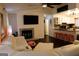 A cozy living room featuring a fireplace, dark wood floors, and an eat-in kitchen at 85 Pine Haven Dr, Carrollton, GA 30116