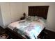 Cozy bedroom showcasing a dark wood headboard with stylish linens, and a dark rug at 85 Pine Haven Dr, Carrollton, GA 30116