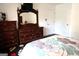 Bedroom showcasing a dresser with a large mirror, and TV. Dark wood furniture with stylish linens at 85 Pine Haven Dr, Carrollton, GA 30116