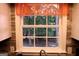 Kitchen window view overlooking a lush green backyard with mature trees and serene natural light at 85 Pine Haven Dr, Carrollton, GA 30116