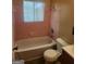 A pink tile bathroom featuring a tub and shower combination at 6485 Boca Grande Blvd, Forest Park, GA 30297