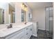 Bathroom featuring dual sinks, vanity with white counters, and tiled shower at 809 Dill Sw Ave, Atlanta, GA 30310