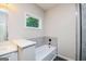 Bathroom featuring a soaking tub with custom tile surround and a glass-enclosed shower at 809 Dill Sw Ave, Atlanta, GA 30310