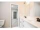 Modern bathroom with double sinks, a marble countertop, stylish fixtures, and an adjoining bedroom at 809 Dill Sw Ave, Atlanta, GA 30310