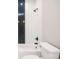 A sleek bathroom showcasing white tile and a chic herringbone accent wall paired with modern, dark fixtures at 809 Dill Sw Ave, Atlanta, GA 30310