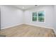 Bedroom featuring hardwood floors, a large window, and neutral paint at 809 Dill Sw Ave, Atlanta, GA 30310