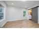 Bedroom boasts hardwood floors, natural light, and a sliding barn door to the bathroom at 809 Dill Sw Ave, Atlanta, GA 30310