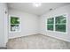 This spacious bedroom features plush carpeting and bright windows with views of mature trees and ample natural light at 809 Dill Sw Ave, Atlanta, GA 30310