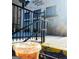 Black Coffee Westside exterior with a black metal fence and glass of iced coffee at 809 Dill Sw Ave, Atlanta, GA 30310