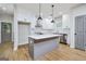 Modern kitchen featuring an island, white cabinetry, stainless steel appliances, and stylish pendant lights at 809 Dill Sw Ave, Atlanta, GA 30310