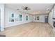 Open-concept living room with large windows offering natural light, beautiful floors, and modern fixtures at 809 Dill Sw Ave, Atlanta, GA 30310