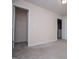 Bedroom featuring neutral carpet, an open door to the walk-in closet, and one to an adjacent room at 411 Hopi Ln, Villa Rica, GA 30180