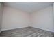 A bedroom view featuring gray wood floors, neutral walls, and electrical outlets at 411 Hopi Ln, Villa Rica, GA 30180