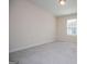 Bright bedroom with neutral walls, carpet, a window for natural light and a light fixture at 411 Hopi Ln, Villa Rica, GA 30180