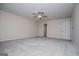 Large primary bedroom with neutral carpet and a ceiling fan at 411 Hopi Ln, Villa Rica, GA 30180