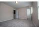 Neutral carpeted bedroom featuring two open doors to adjacent rooms at 411 Hopi Ln, Villa Rica, GA 30180