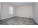 This bedroom has luxury vinyl plank flooring and a bright window at 411 Hopi Ln, Villa Rica, GA 30180