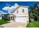 Two-story home featuring an attached garage, manicured lawn, and blue sky at 411 Hopi Ln, Villa Rica, GA 30180