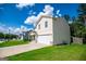 Street view of a two-story home featuring a two-car garage and a well-maintained lawn at 411 Hopi Ln, Villa Rica, GA 30180