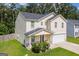 Side view of a two-story home with attached garage and well-manicured lawn at 411 Hopi Ln, Villa Rica, GA 30180