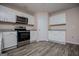 Well-lit kitchen featuring stainless steel appliances and stylish white cabinetry at 411 Hopi Ln, Villa Rica, GA 30180