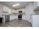 Bright kitchen with white cabinets, stainless steel appliances, and granite countertops at 411 Hopi Ln, Villa Rica, GA 30180