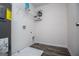 Spacious laundry room featuring a utility sink, washer and dryer hookups, and wire rack shelving at 411 Hopi Ln, Villa Rica, GA 30180