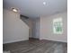 An entry room featuring wood floors, a white door, a window, and stairs to the second floor at 411 Hopi Ln, Villa Rica, GA 30180
