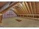 Unfinished attic space with exposed wooden beams and a small window at 821 Carnellian Ln, Peachtree City, GA 30269