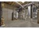 Spacious basement room featuring utilities such as a water heater and HVAC system set against a concrete wall at 821 Carnellian Ln, Peachtree City, GA 30269