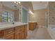 Bright bathroom featuring dual vanities, tub, light tile flooring and floral wallpaper at 821 Carnellian Ln, Peachtree City, GA 30269
