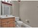 Powder bath features wallpaper, a mirror, toilet, vanity and cabinet at 821 Carnellian Ln, Peachtree City, GA 30269