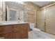 Vintage-themed bathroom featuring a wood vanity, white sink, toilet, and a shower with sliding glass doors at 821 Carnellian Ln, Peachtree City, GA 30269