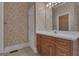 Cozy bathroom featuring a vanity and floral wallpaper at 821 Carnellian Ln, Peachtree City, GA 30269