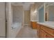 Bright bathroom featuring a tub, light tile flooring, and a vanity at 821 Carnellian Ln, Peachtree City, GA 30269