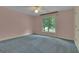 Clean, carpeted bedroom with pastel pink walls and lots of light at 821 Carnellian Ln, Peachtree City, GA 30269